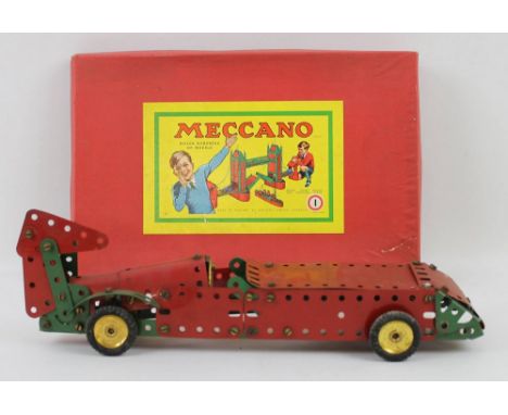 A quantity of vintage Meccano, with original boxes, comprising building set 3, accessories sets 1A and 3A and a part built ca