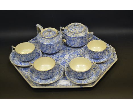 A Staffordshire blue and white tete a tete comprising of a tray , teapot, sucrier, four cups and saucers
