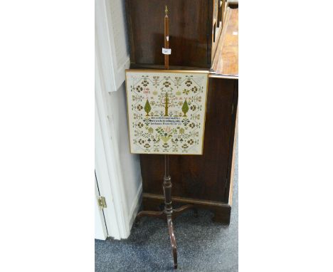 An Edwardian tapestry  pole screen,  mounted with a later sampler