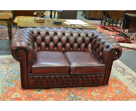 A contemporary faux fur leather oxblood red Chesterfield two seater sofa 72cm x 760cm x 90cm 