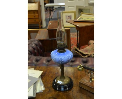 A Victorian oil lamp, acanthus scrolling embossed reservoir, weighted base c 1900