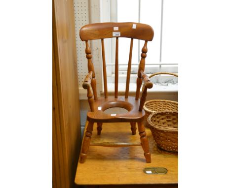 An early 20th century beech child's Windsor commode  