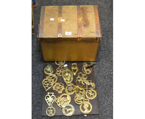 An early 20th Century domed trunk, copper banded; a set of 19th Century horse brasses; another (3)