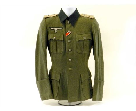 A German Third Reich Field Service Army tunic to a Leutnant in the 4 th Infantry Regiment constructed of field grey wool with