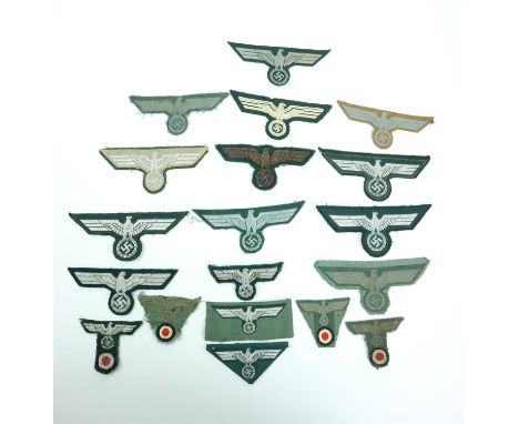 Twelve German Third Reich Army breast eagles together with seven German Third Reich Army visor and M43 cap eagles (19)