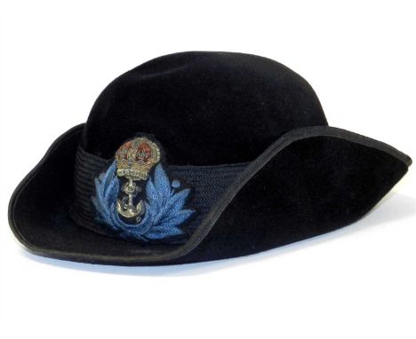 A World War II British WRNS (Women’s Royal Naval Service) officer tricorn cap constructed of black velvet with ribbed centreb