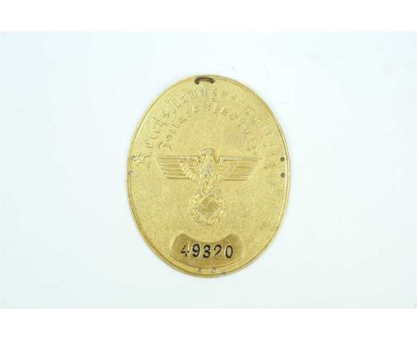 A German Third Reich Customs Protection Officer’s arm shield circa 1937-40 of oval form, die struck shield in gilded aluminiu