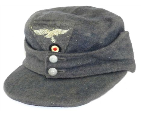 A German Third Reich Luftwaffe EM/NCO'S M43 field cap (Einheitsfliegermütze M43) constructed of a blue/grey rayon and wool bl