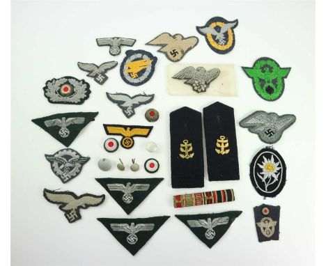 A grouping of mixed German Third Reich cloth insignia including Schutzpolizei sleeve eagle, RLB uniform eagle, eidelweiss pat