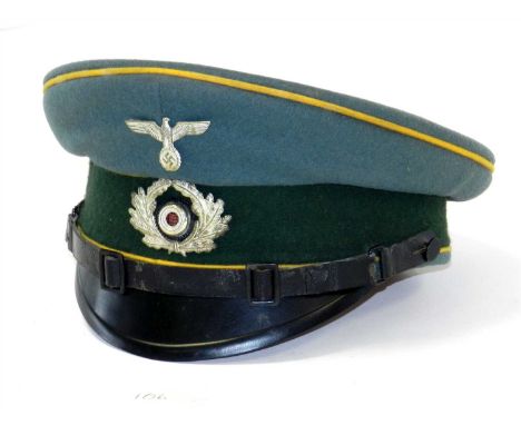 A German Third Reich Army Cavalry NCO/EM visor cap constructed of green doeskin wool with a forest green centreband and golde