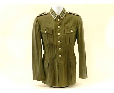 A German Third Reich Denim Field Service Tunic to an Enlisted Unteroffizier in the Armoured Infantry (early pattern shoulder 