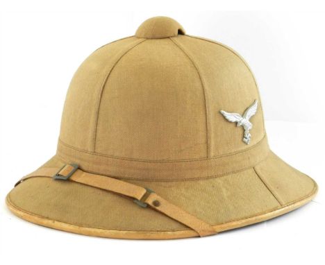 A German Third Reich Luftwaffe pith helmet formed of six panels, the cloth covered cork helmet in tropical brown, helmet is c