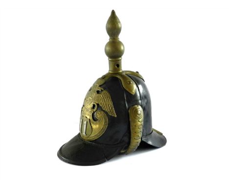 A mid-19th century Imperial Russian NCOs leather helmet of the 11th Infantry Regiment, black leather skull with brass mounts,