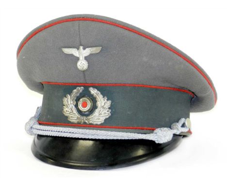 A German Third Reich Army Artillery Officer’s visor cap by Pekuro a late war example circa 1944-45 constructed of thick weave