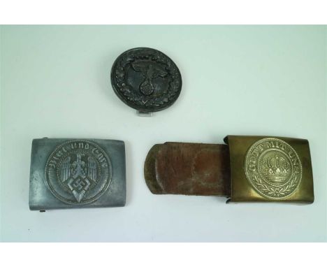 A German Third Reich Hitler Jugend aluminium belt buckle by Assman and Sohn (RZM M4/49) together with a brass and silver fini