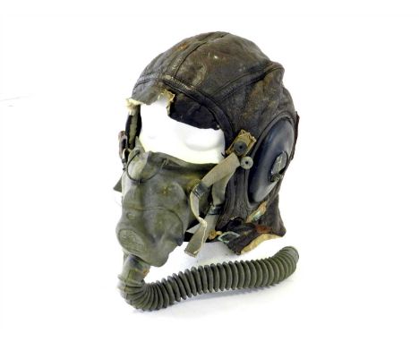 A World War II U.S Army Air Force leather flying helmet dated 1943 with type A-10 Oxygen Mask