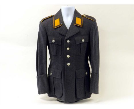 An early pattern German Third Reich Luftwaffe Flight Section Service tunic constructed of navy blue wool, the four pocket sin