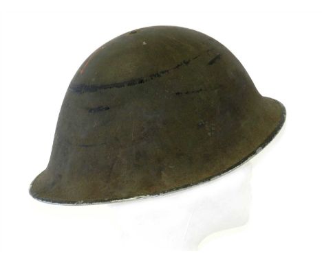 A First World War US Army M17 steel helmet retaining rough textured exterior finish, with interior black leather liner but la