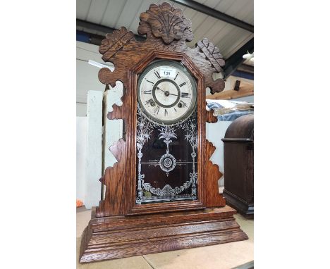 An oak cased wall clock "gingerbread" mantel clock by Ansonia USA 