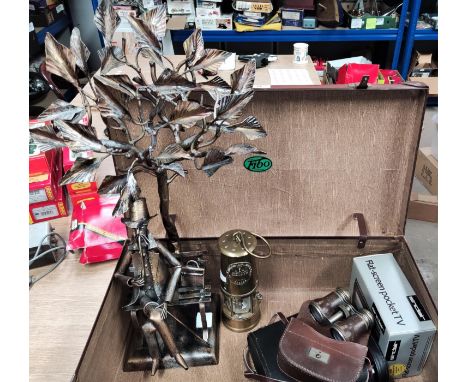A miner's lamp; opera glasses; binoculars; a cast metal figure of a man under a tree, height 66 cm; a vintage portable TV; et