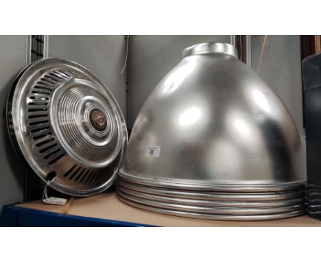 Five large industrial light shades in silvered metal; 2 vintage chrome hub caps 