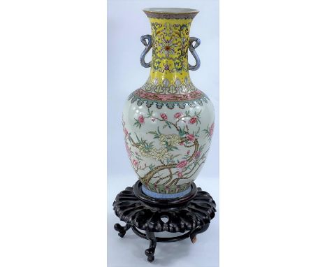 A Chinese Republic period porcelain vase of baluster form, with loop handles, decorated in the Qianlong style with branches o