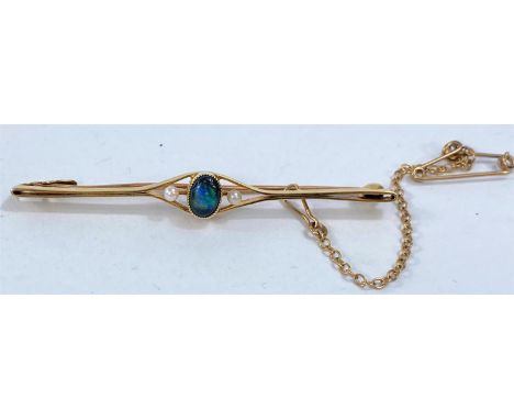 A yellow metal bar brooch stamped 15ct set with central black opal and 2 seed pearls, 3gm 