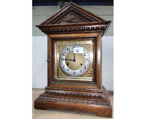 An Edwardian mantel clock in architectural oak case, with striking movement 