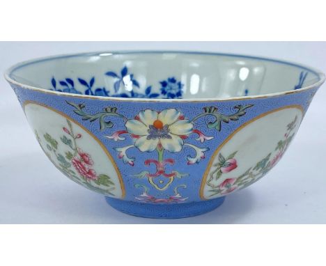 A Chinese porcelain bowl with embossed enamel ground, surrounding four oval reserves decorated with flowers, underglaze blue 