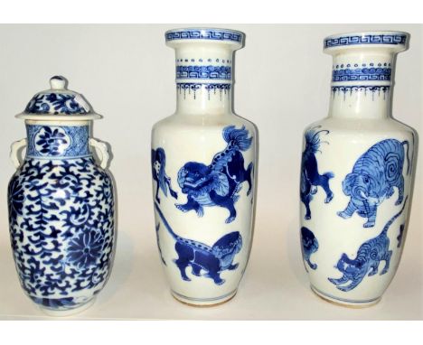 A pair of Chinese porcelain rouleau vases decorated in underglaze blue with wild animals, 4 character mark,, 24cm; another va