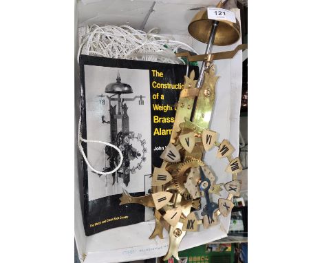 A wall mounted "Weight Driven Bray Alarm Clock" with booklet 