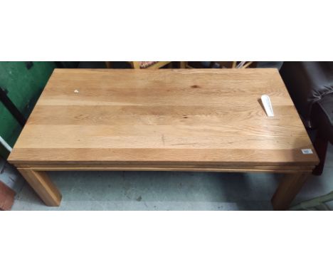 A modern light wood rectangular coffee table 