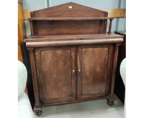 An early Victorian mahogany Chiffonier, the arched raised back with display shelf, pulvinated frieze, double door cupboard fl