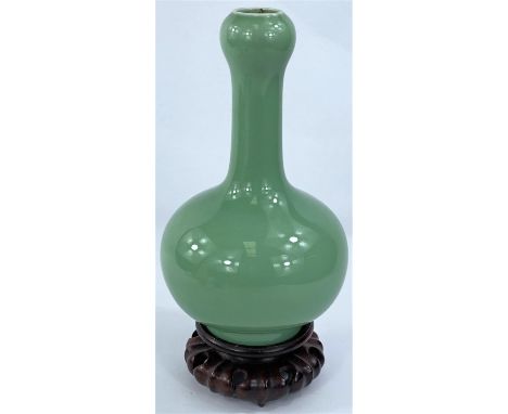 A Chinese green enamelled porcelain onion form vase, 20cm and hardwood stand (Good condition)