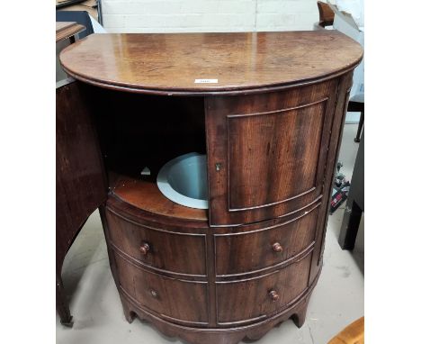 A 19th century mahogany demi-lune commode with hinged top, double doors, false fascias, and original pot 