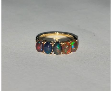 A 9 carat hallmarked gold ring set with 5 "midnight" opal coloured stones 2.8gm 