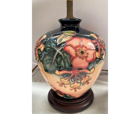 A squat modern Moorcroft baluster table lamp decorated with honeysuckle etc against a pink ground