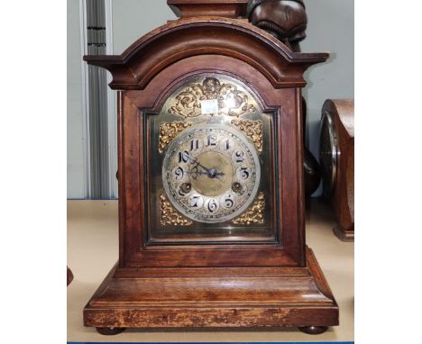 An architectural stained walnut cased mantel clock with brass dial and striking movement 