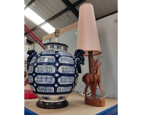 A large blue and white baluster lamp base and a carved antelope lamp 