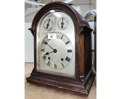 An oak cased bracket clock, c. 1900, silvered dial, domed top with carry handle, key and pendulum 