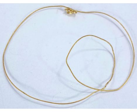 A yellow metal wire chain stamped 585, 2.5gm (bent) 