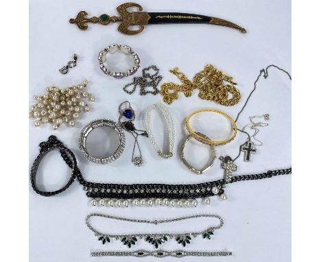 A selection of costume jewellery including diamante bracelets, necklaces, a gilt bangle set with simulated rubies, a Middle E