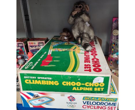 A vintage Toy Town set, Alpine Climbing Choo-Choo, boxed; a Velodrome Scalextric; a vintage monkey with turning head; another