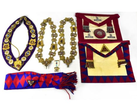A small brown vintage case containing a quantity of Masonic regalia to include aprons, sash, various jewels, for the Masonic 