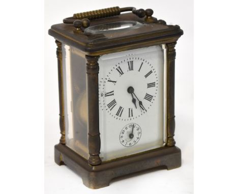 A late 19th/early 20th century French brass carriage clock, the enamelled dial set with Roman numerals and secondary dial set