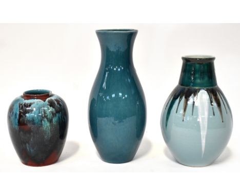 POOLE; three varying shaped vases to include a blue ground baluster vase in 'Dolphin' design, a baluster vase with flambé blu