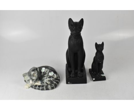 A group of three cat figures to include a ceramic example by Mike Hinton and two plaster black Egyptian cats, height of talle
