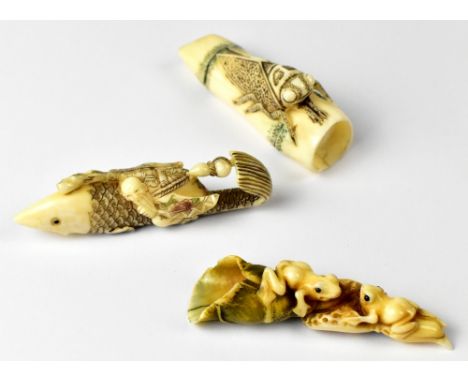 Three Japanese netsuke one in the form of a grasshopper sitting on a piece of bamboo, a fish with a wise man riding on his ba