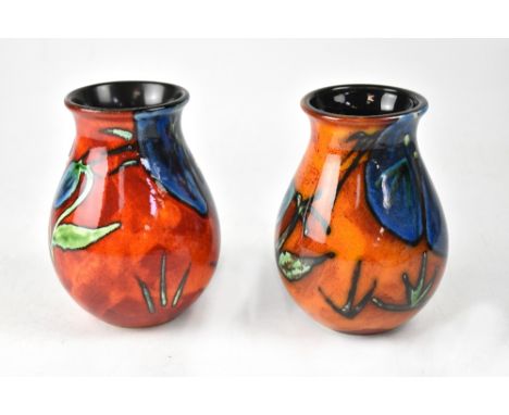 POOLE; two 'Himalayan Poppy' design baluster vases in different colourways, initialled to bases 'B' and 'YH', height of each 