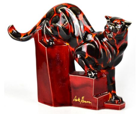 ANITA HARRIS; a large signed ceramic model of a cheetah, on a stylised stepped rocky plinth, height 24cm, length 28cm.